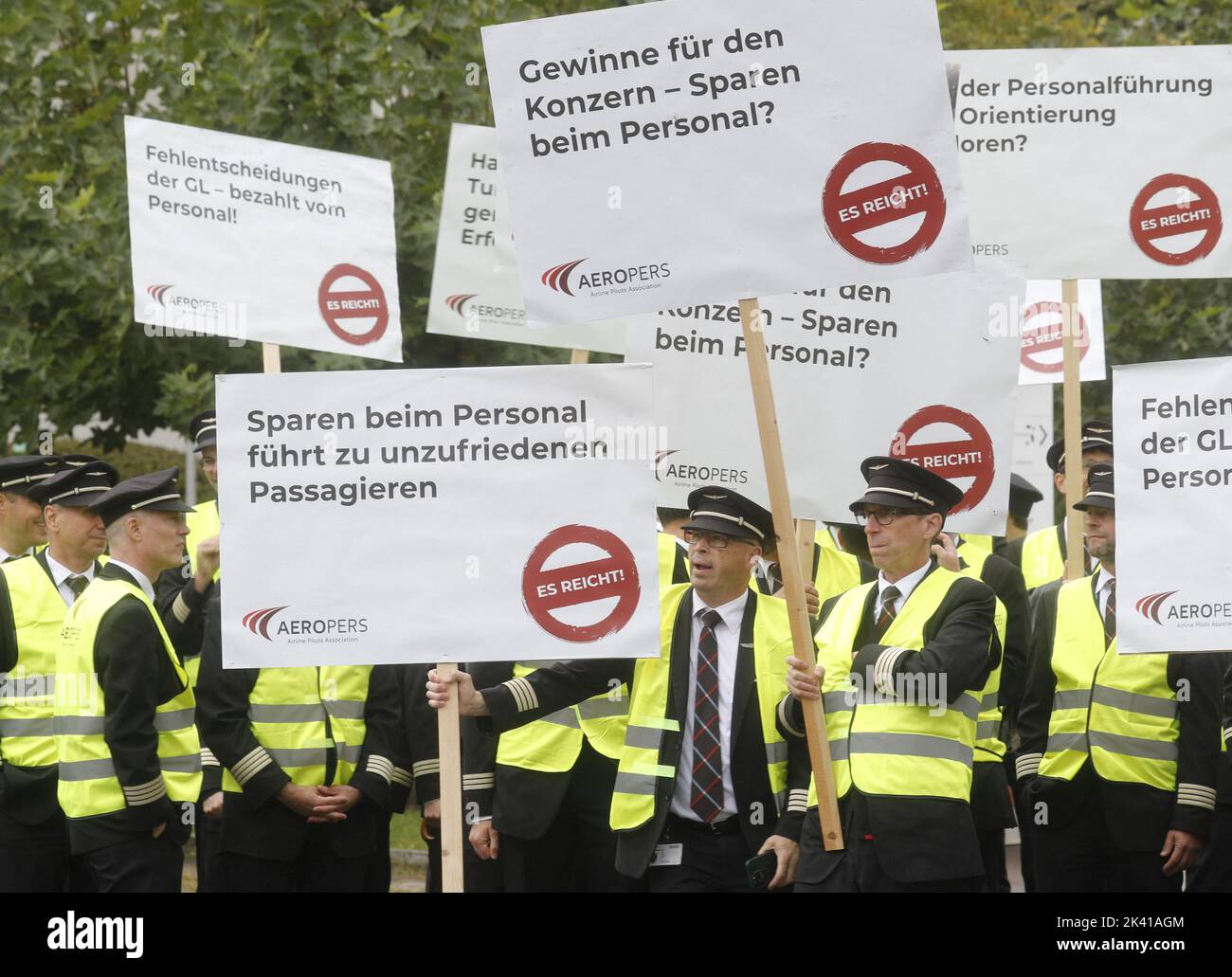 Members of AEROPERS - Airline Pilots Association display posters during a protest in front of the headquarters of Swiss International Air Lines in Kloten, Switzerland September 29,  2022.  REUTERS/Arnd Wiegmann Stock Photo