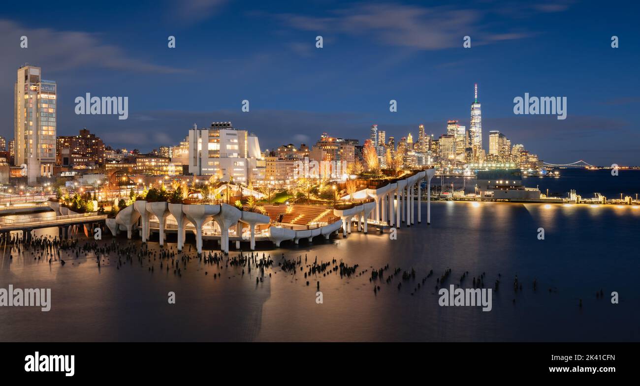 New York City, Little Island public park at dusk with view of the World Trade Center. Elevated park with amphitheater at Hudson River Park (Pier 55) Stock Photo