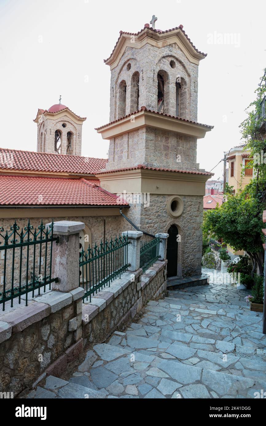 St. John Orthodox Church, Arachova Greece religious destination Viotia. Temple with two belfries, blue sky. Cobblestone stairs. Vertical Stock Photo