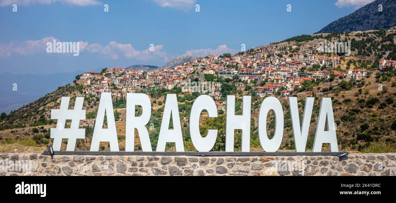 Arachova Greece village perched on Parnassos Mountain, Viotia. Panoramic view of resort for outdoor activities. Name made of steel on stone wall. Stock Photo