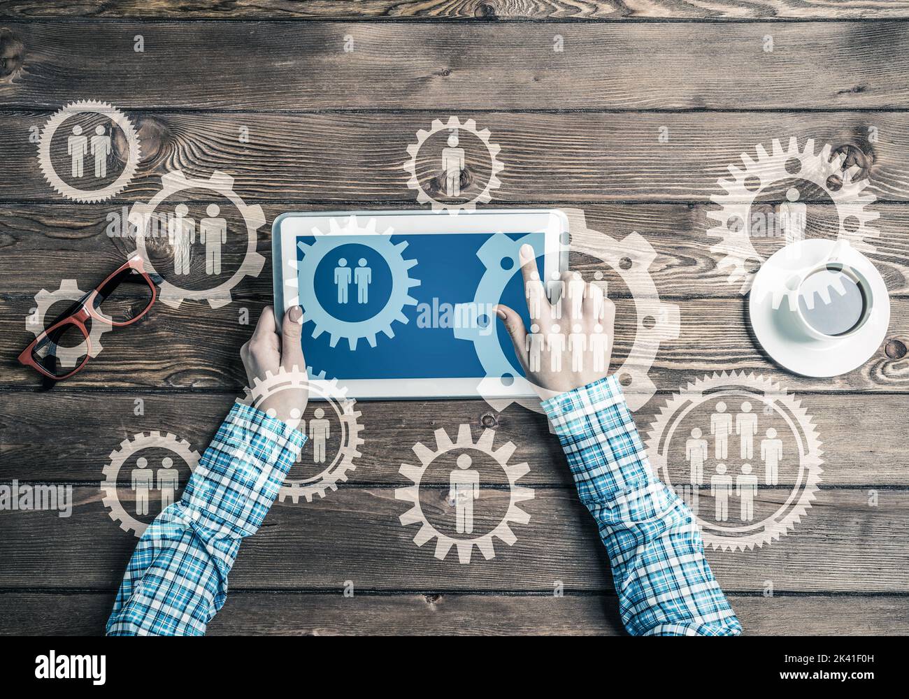 Concept of teamworking and connection with gears mechanism and tablet pc Stock Photo