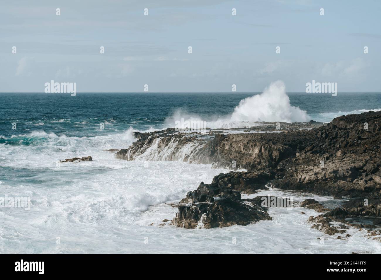 Water splash on black volcanic rocks of Tenesar, Lanzarote, Canary ...