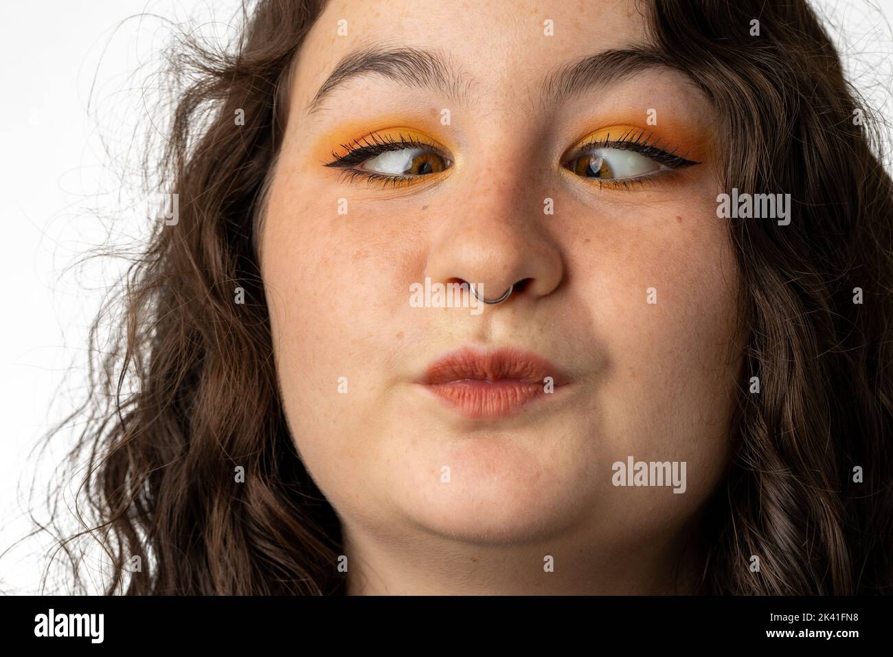 Close-up of beautiful woman making funny cross-eyed face Stock Photo