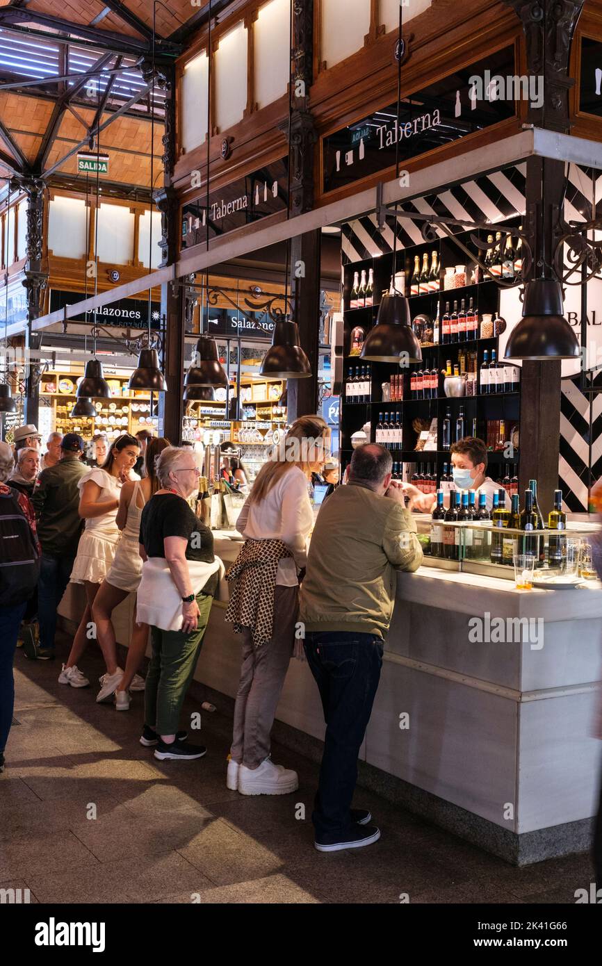 Spain, Madrid. Market of San Miguel. Patrons at a Wine Bar. Stock Photo