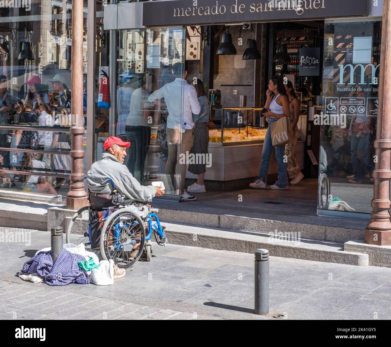 Spain, Madrid. Beggar Outside the Market of San Miguel. Stock Photo