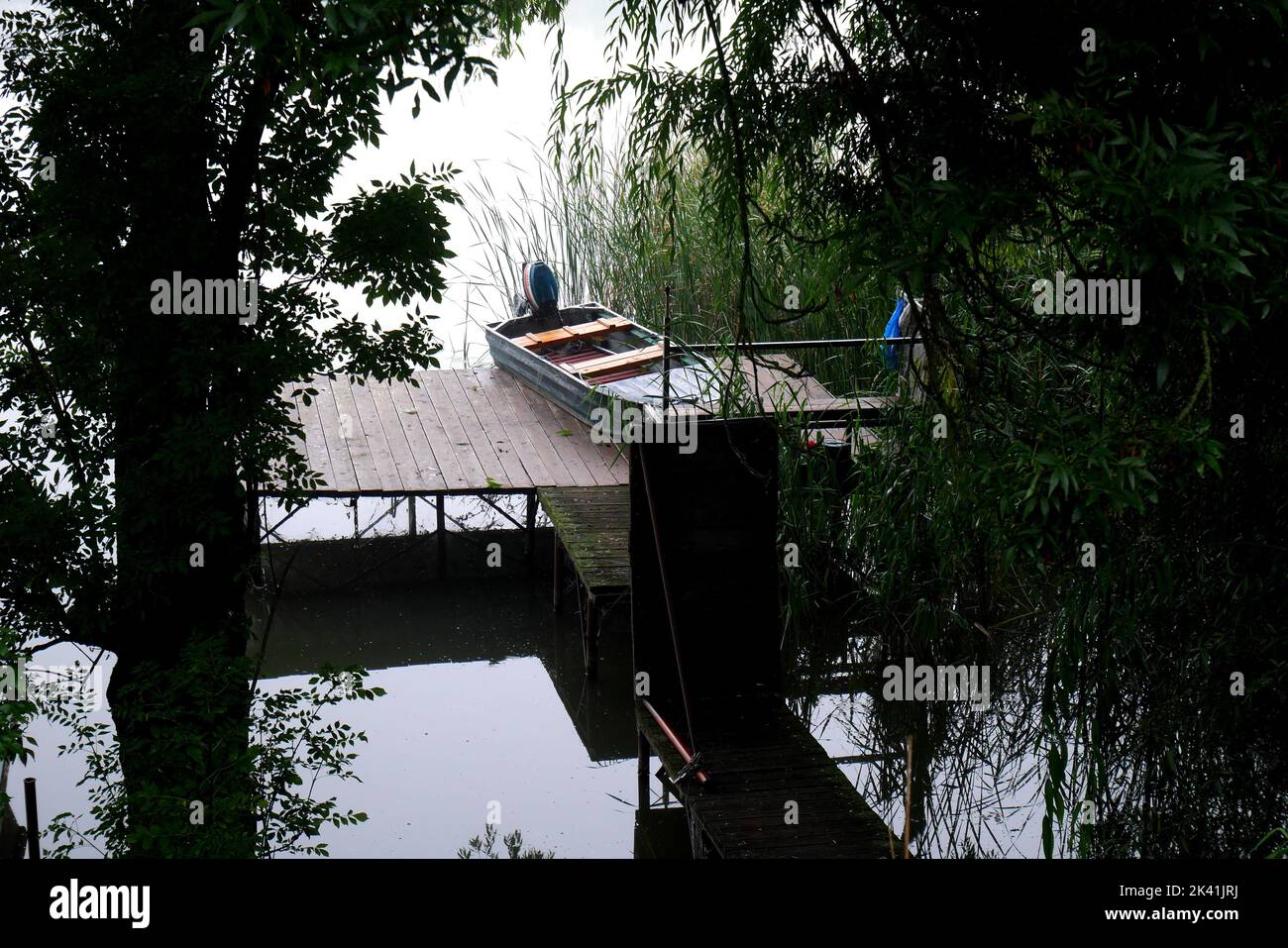 Rowing boat moored at a landing stage on a foggy morning on the River Danube, Szigethalom, Hungary Stock Photo
