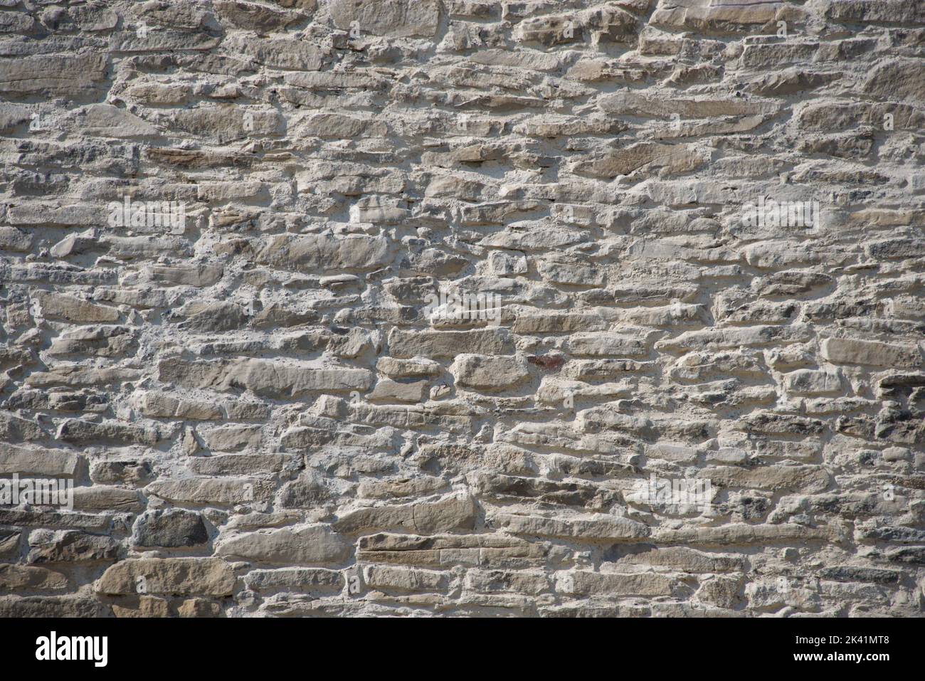Monochromatic background old stone wall narrow Stock Photo