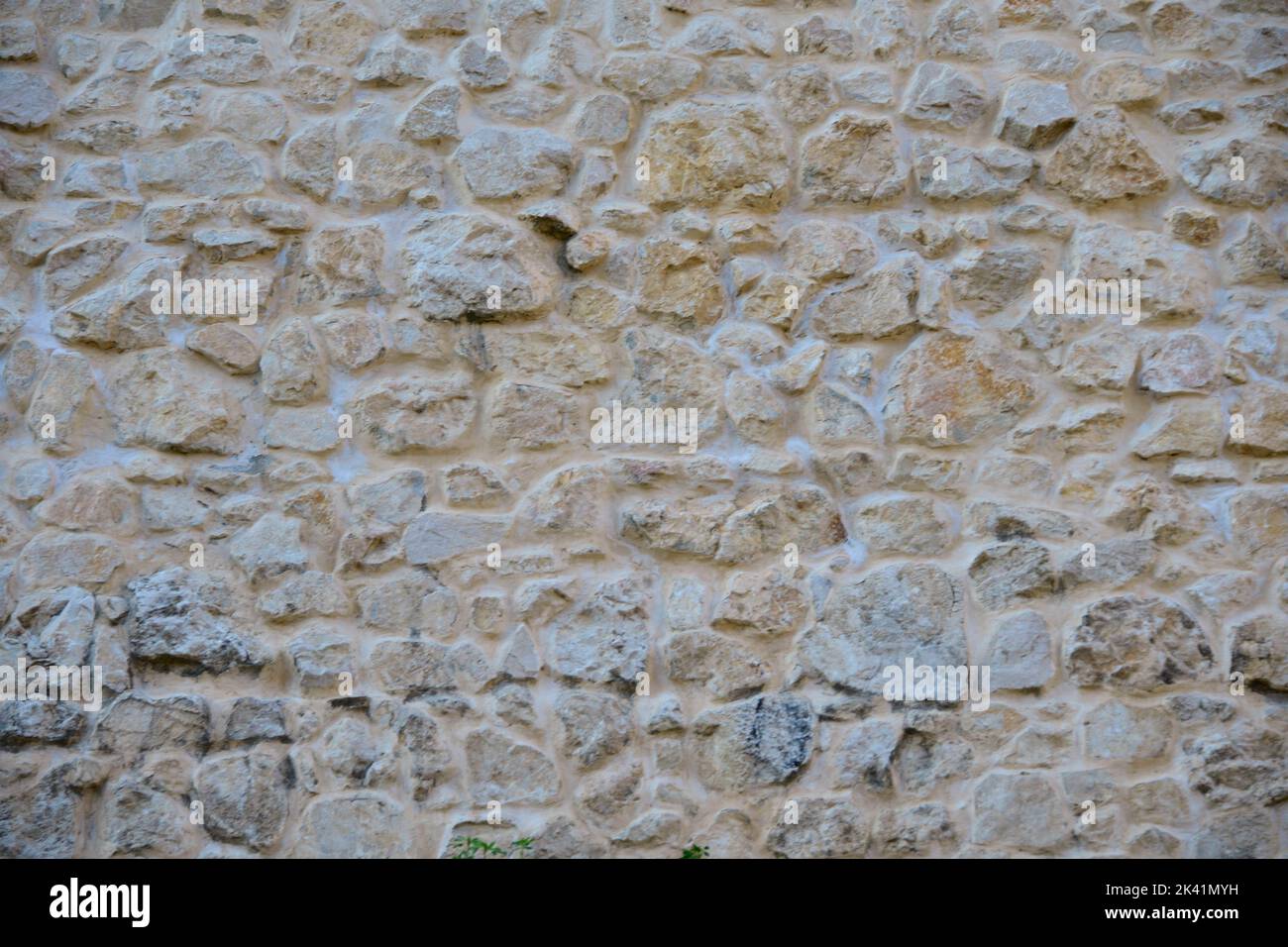 Rustic stone wall plastered on it Stock Photo