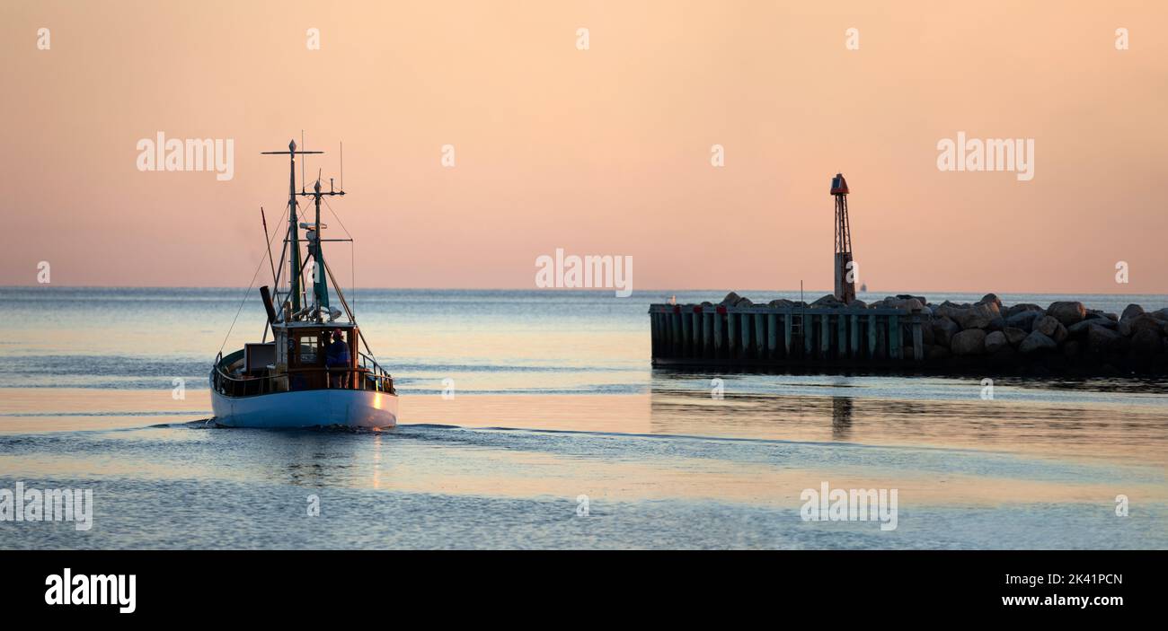 Fishing trawler leaving Gilleleje harbour in early morning, Gilleleje, Zealand, Denmark, Europe Stock Photo