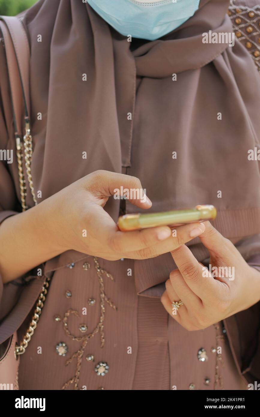 young women with face mask using smart phone  Stock Photo