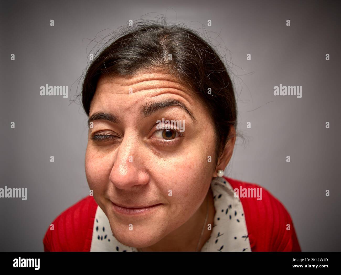 Woman winking at the viewer stock photo alamy