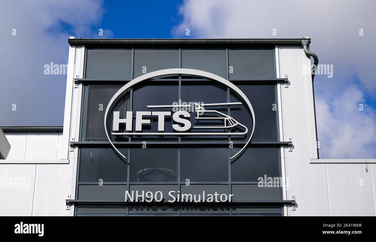 20 September 2022, Lower Saxony, Faßberg: The lettering of HFTS (Helicopter Flight Training Services GmbH), NH90 Simulator stands on a building on the grounds of Faßberg Air Base. Photo: Philipp Schulze/dpa Stock Photo