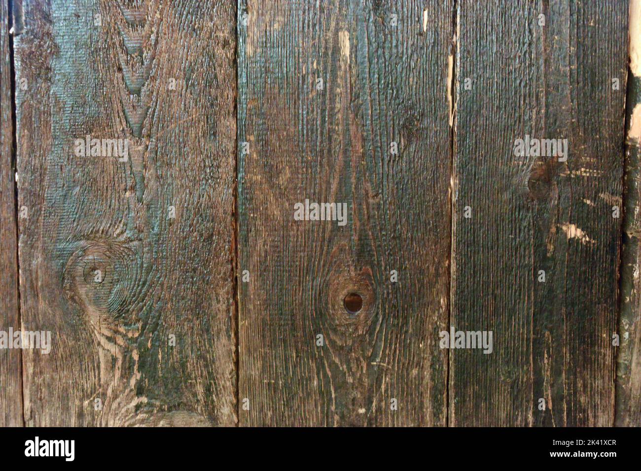 Wood texture background. Wooden fence treated with engine oil burned