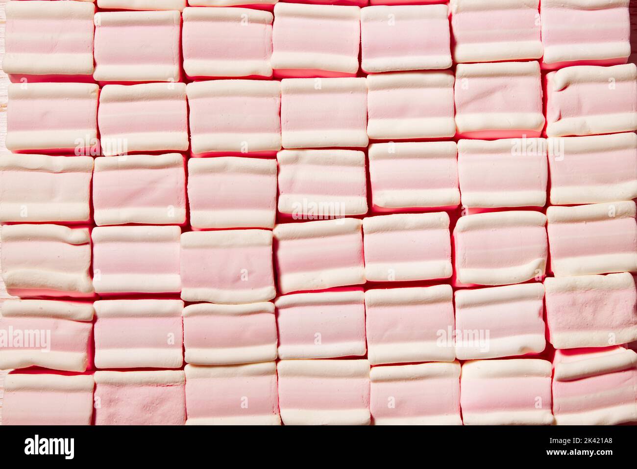 the pattern of sweet pink square shape marshmallow. Flat lay, top view. Stock Photo