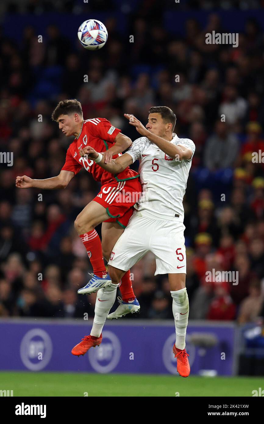 Daniel James of Wales collides with Jan Bednarek of Poland (r). UEFA Nations league, group D match, Wales v Poland at the Cardiff city stadium in Card Stock Photo