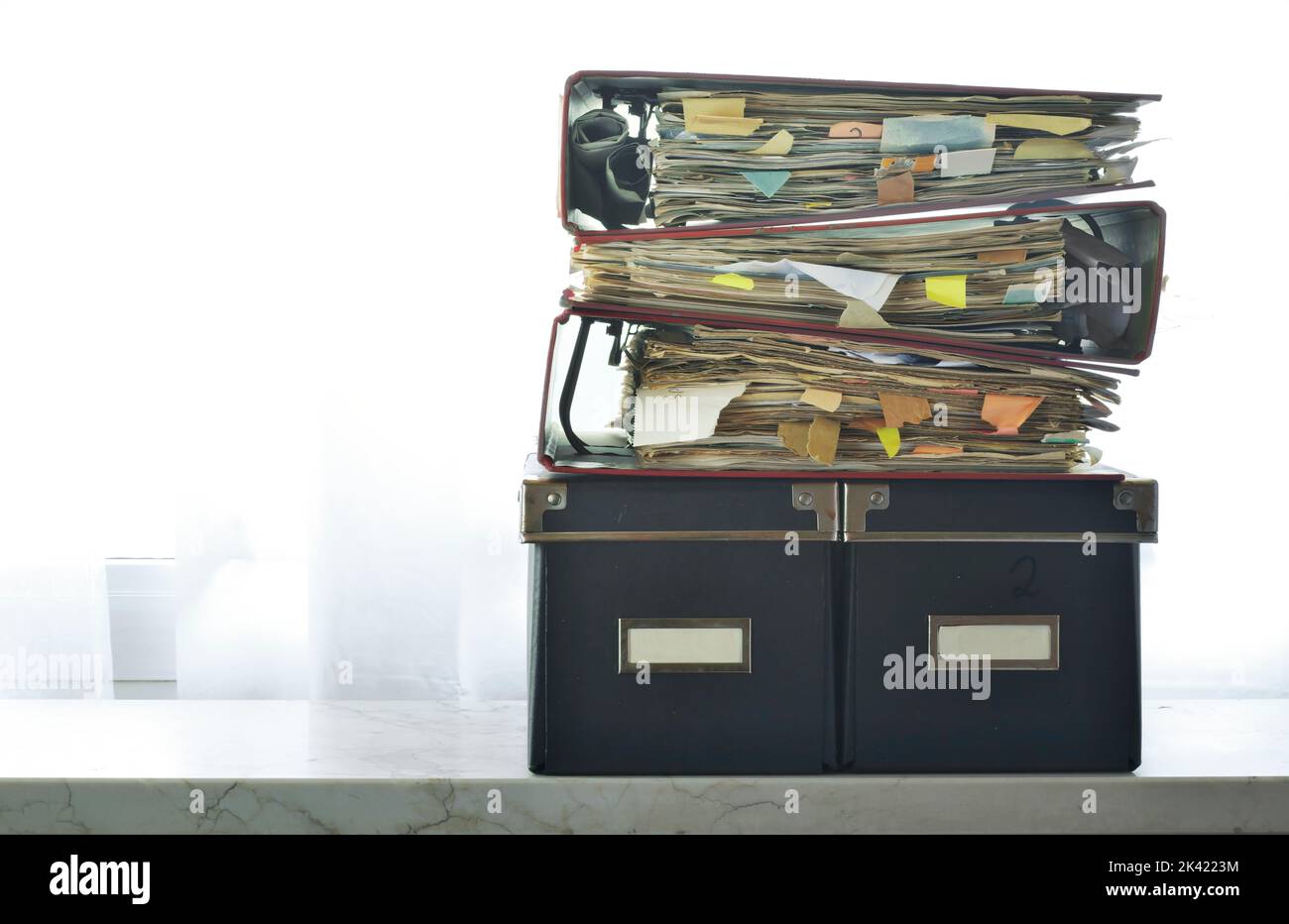 stack of messy file folders,red tape, bureaucracy,aministration