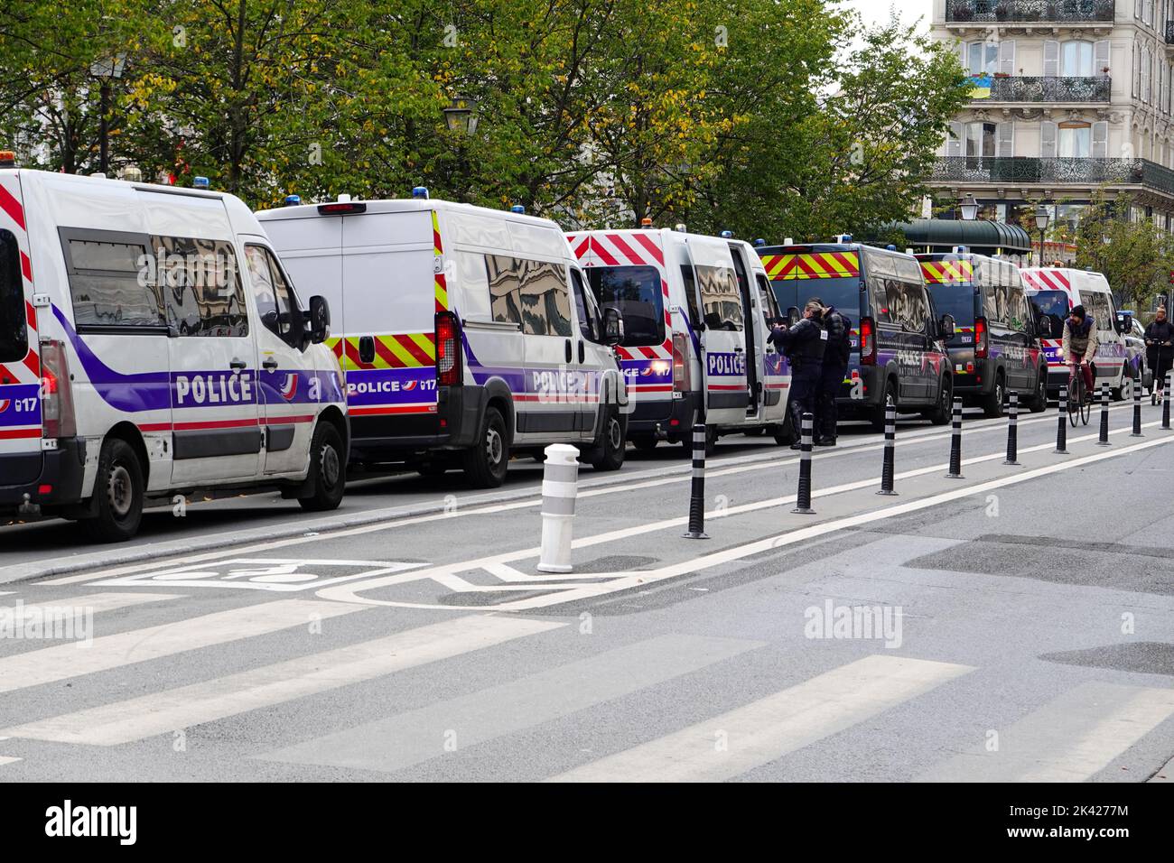 Thursday, 29 September 2022. Paris, France. Union demonstrators peacefully march from Denfert-Rochereau to Place Bastille, on nationwide day of workers protests, calling for an increase in wages due to the rise of the cost of living, and also in protest of plans by President Emmanuel Macron to reform the French retirement system. Police vehicles a line on nearby. Stock Photo