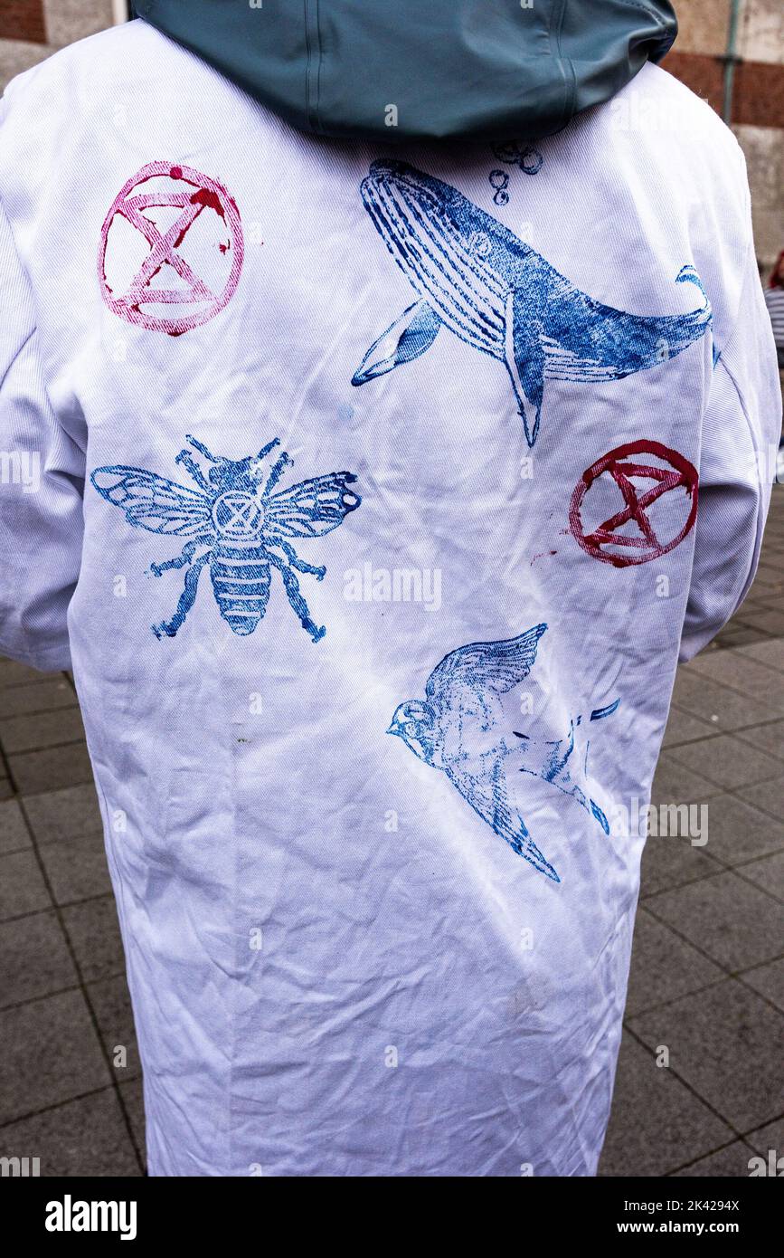 Illustrated lad-coat depicting the dire consequences of global warming seen during the demonstration. Scientist protest against gas drilling under the Wadden Sea off The Netherlands coast. The Dutch government will soon decide on a new permit for gas drilling under the Wadden Sea, which is situated in the southeastern part of the North Sea. ‘Scientist Rebellion’ , an international movement of scientists extremely concerned about the climate and ecological crisis, is calling on the government not to grant that permit. To reinforce this appeal, Scientist Rebellion has organized a demonstration f Stock Photo