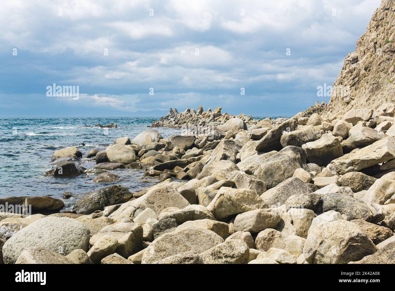 sharp jagged basalt rocks on the sea coast, Cape Stolbchaty on Kunashir Island Stock Photo