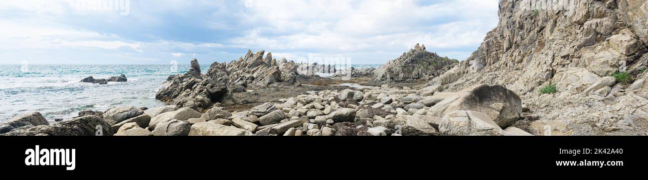 sharp jagged basalt rocks on the sea coast, Cape Stolbchaty on Kunashir Island Stock Photo
