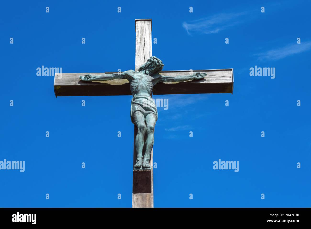 Statue of Christ on the cross against a blue sky in France Stock Photo ...