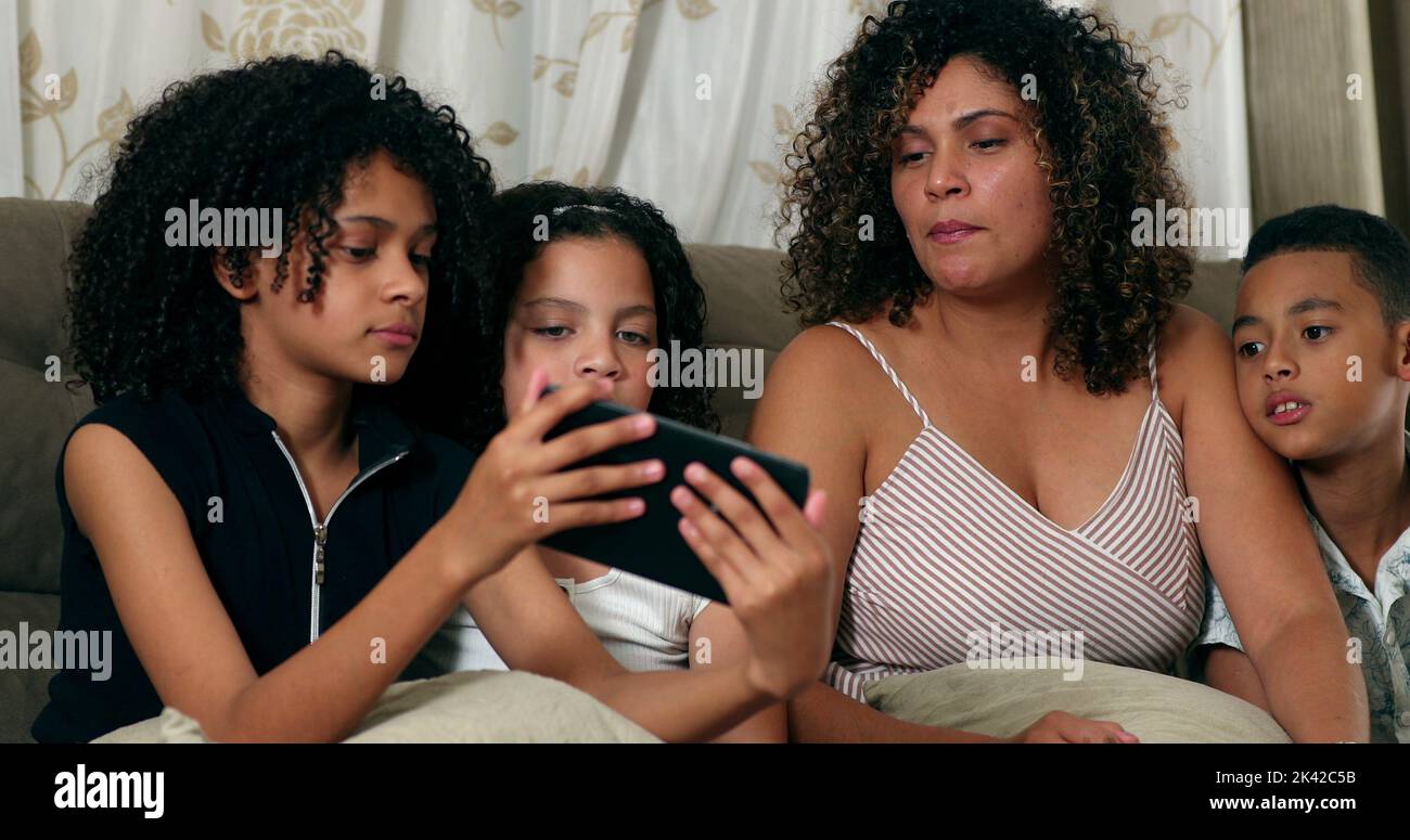 Brazilian family speaking communication tablet device with children ...