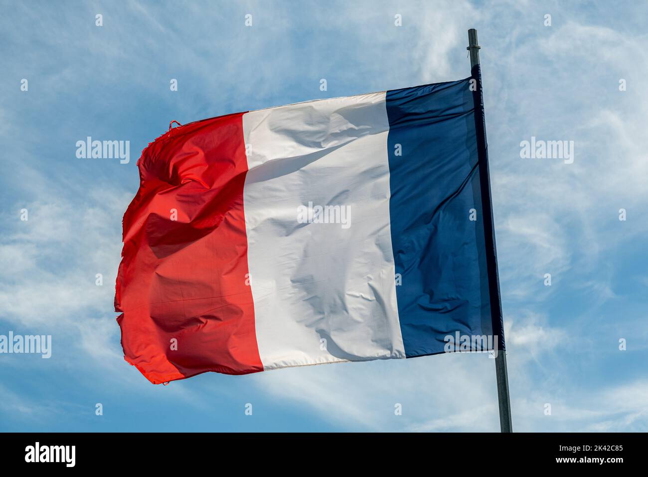 French flag over blue sky Stock Photo