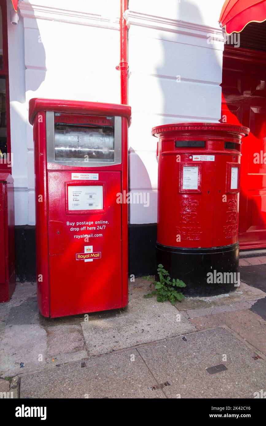 Royal Mail letter box / GPO red Post box beside a Parcel and priority