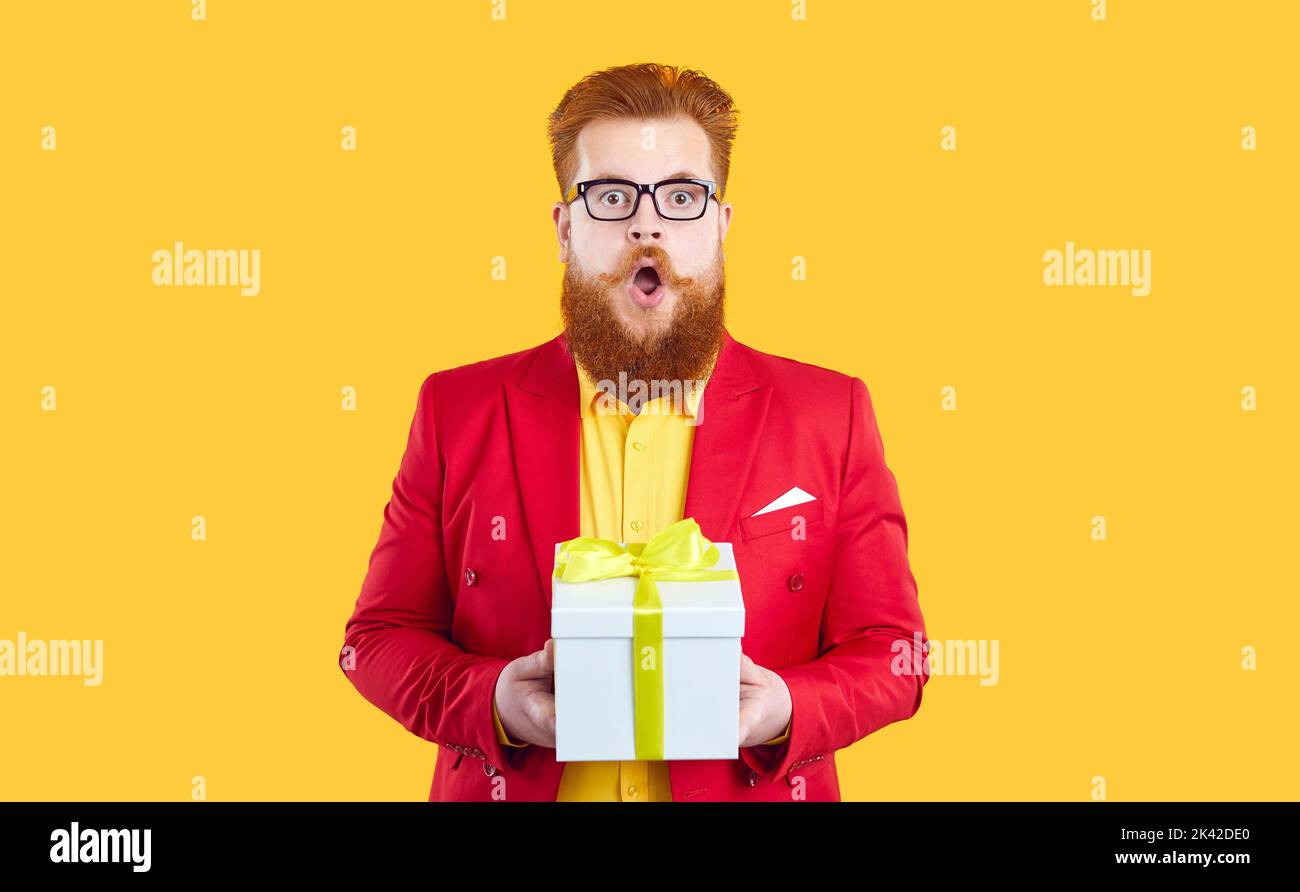 Funny chubby redhead bearded young man in red jacket and glasses gets