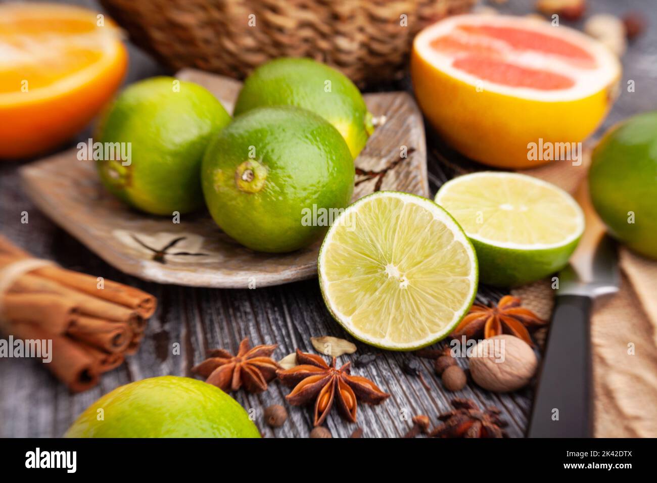 sliced lime on a plate on wood background Stock Photo