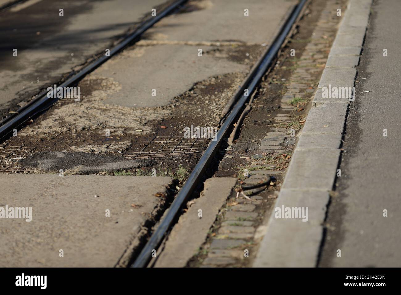 Shallow depth of field (selective focus) details with old, rusty and worn out tram rails on the streets of Bucharest. Stock Photo