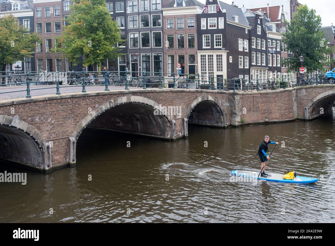 Paddle Boarder on canal - Amsterdam, The Netherlands Stock Photo