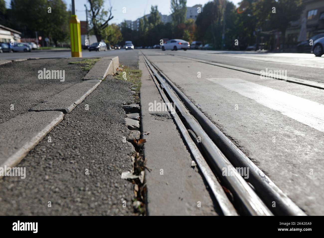 Shallow depth of field (selective focus) details with old, rusty and worn out tram rails on the streets of Bucharest. Stock Photo