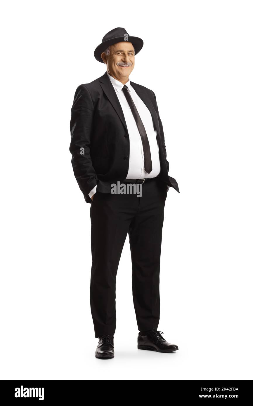 Elegant mature man in black suit and tie wearing a fedora hat isolated on white background Stock Photo