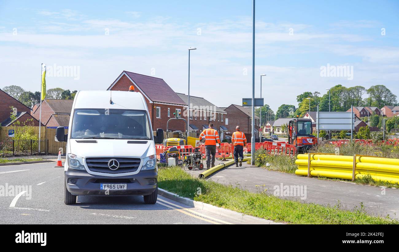 Construction workers laying gas pipes on a new housing estate in Worcestershire, UK. Stock Photo