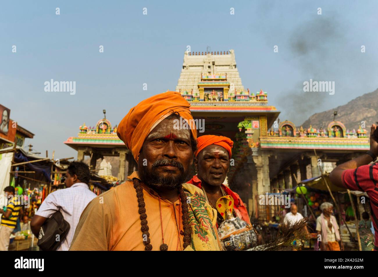 Tiruvannamalai, Tamil Nadu, India : Two religious men dressed in saffron stand outside Annamalaiyar temple, one of the five main Shaiva holy places as Stock Photo