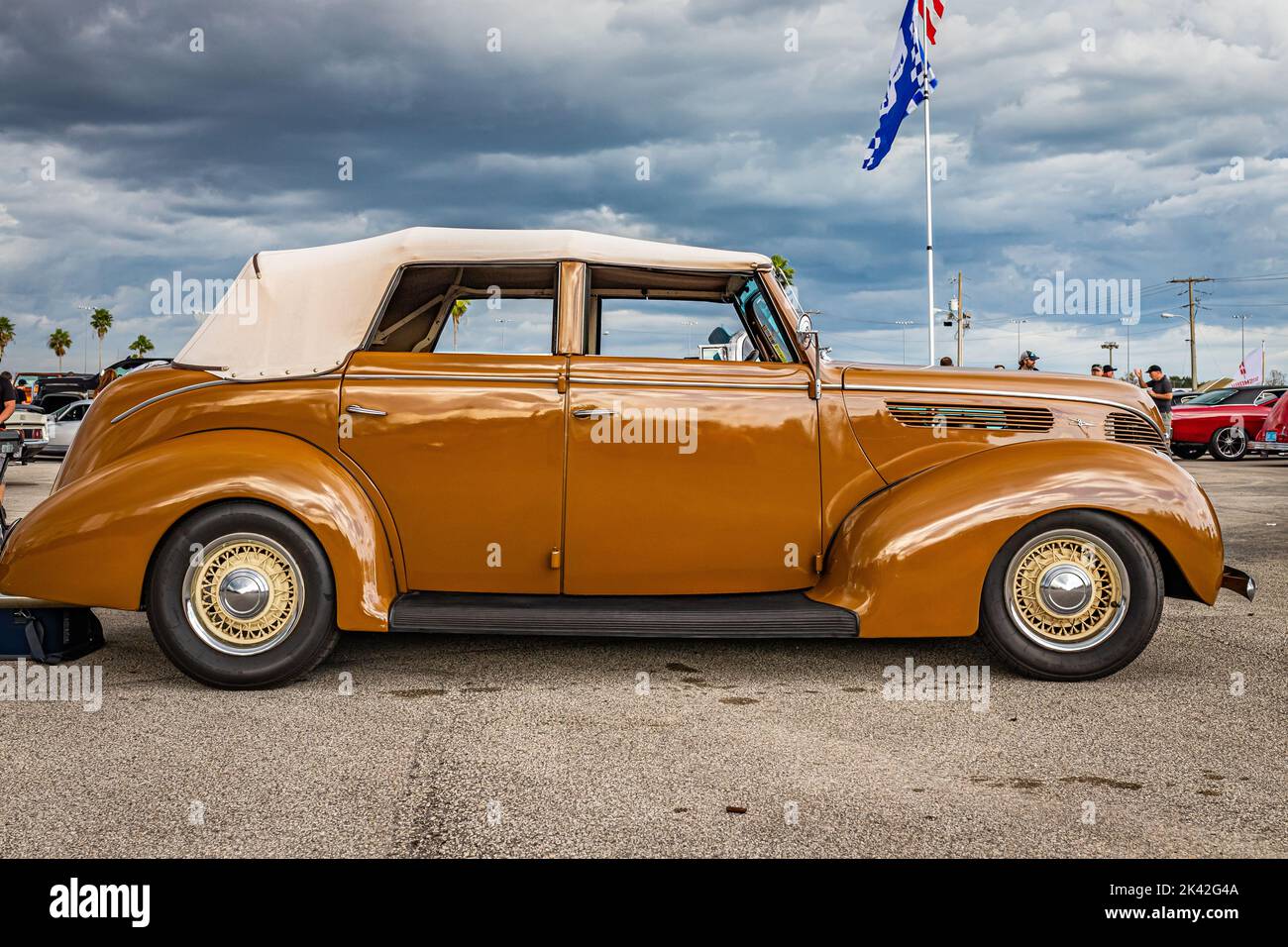 Daytona Beach, FL - November 28, 2020: Low perspective side view of a 1938 Ford Deluxe Model 82A 4 Door Convertible Sedan at a local car show. Stock Photo