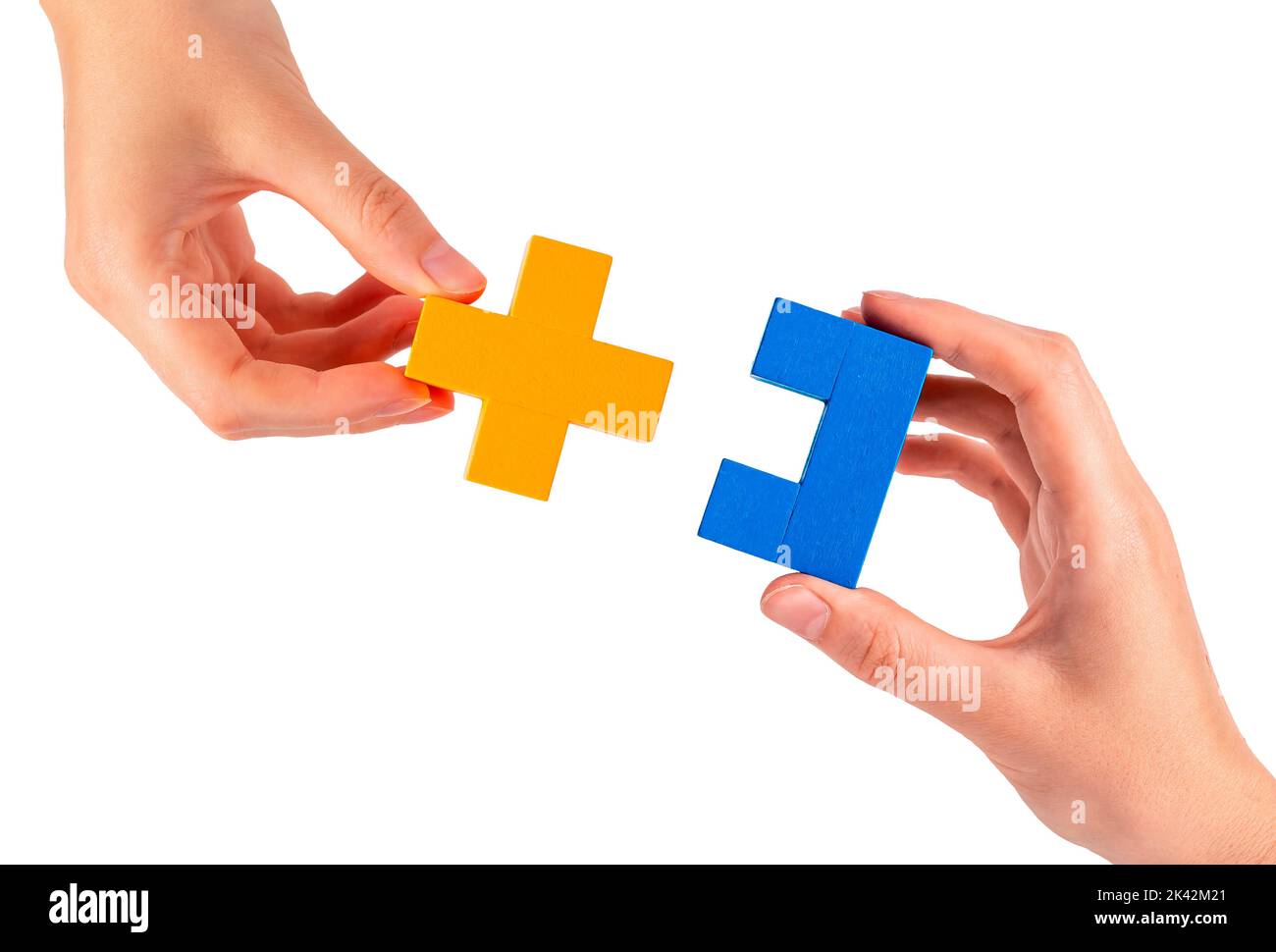 Connection, teamwork concept. Hands with puzzle pieces connecting two matching parts. High quality photo Stock Photo