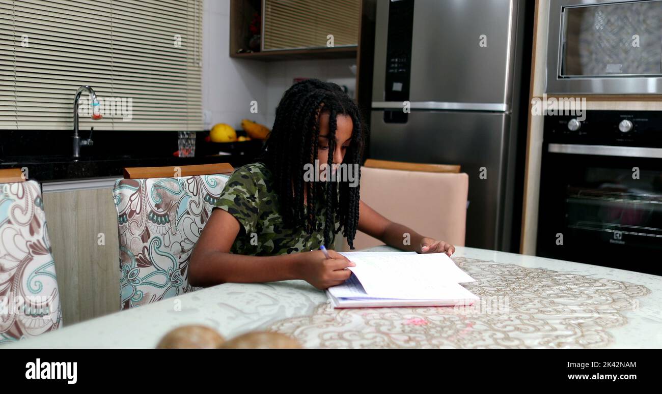 Candid black teen girl studying at home doing homework Stock Photo - Alamy