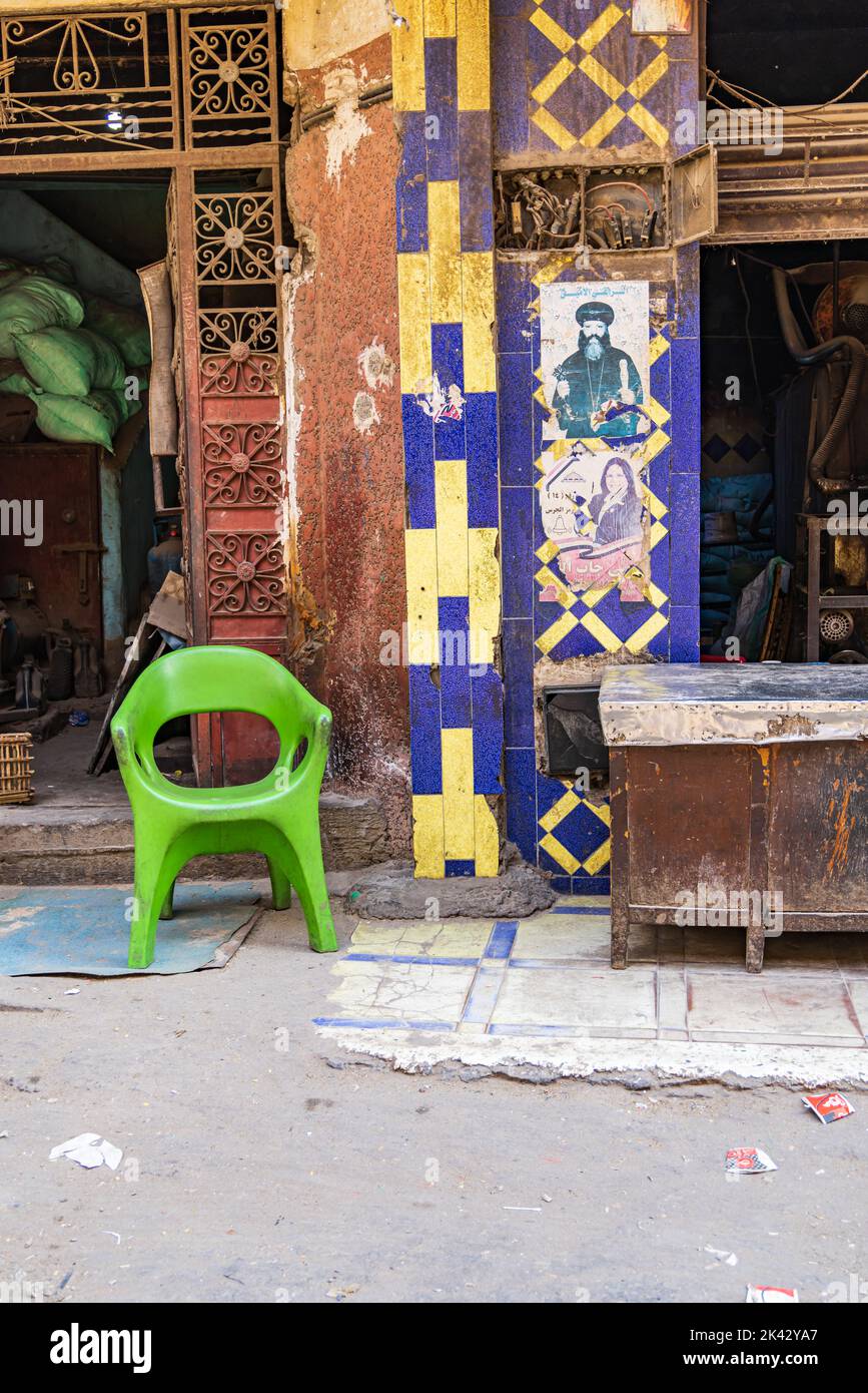 Manshiyat Naser, Garbage City, Cairo, Egypt. February 14, 2022. Green chair on a street in Manshiyat Naser, Garbage City, Cairo. Stock Photo