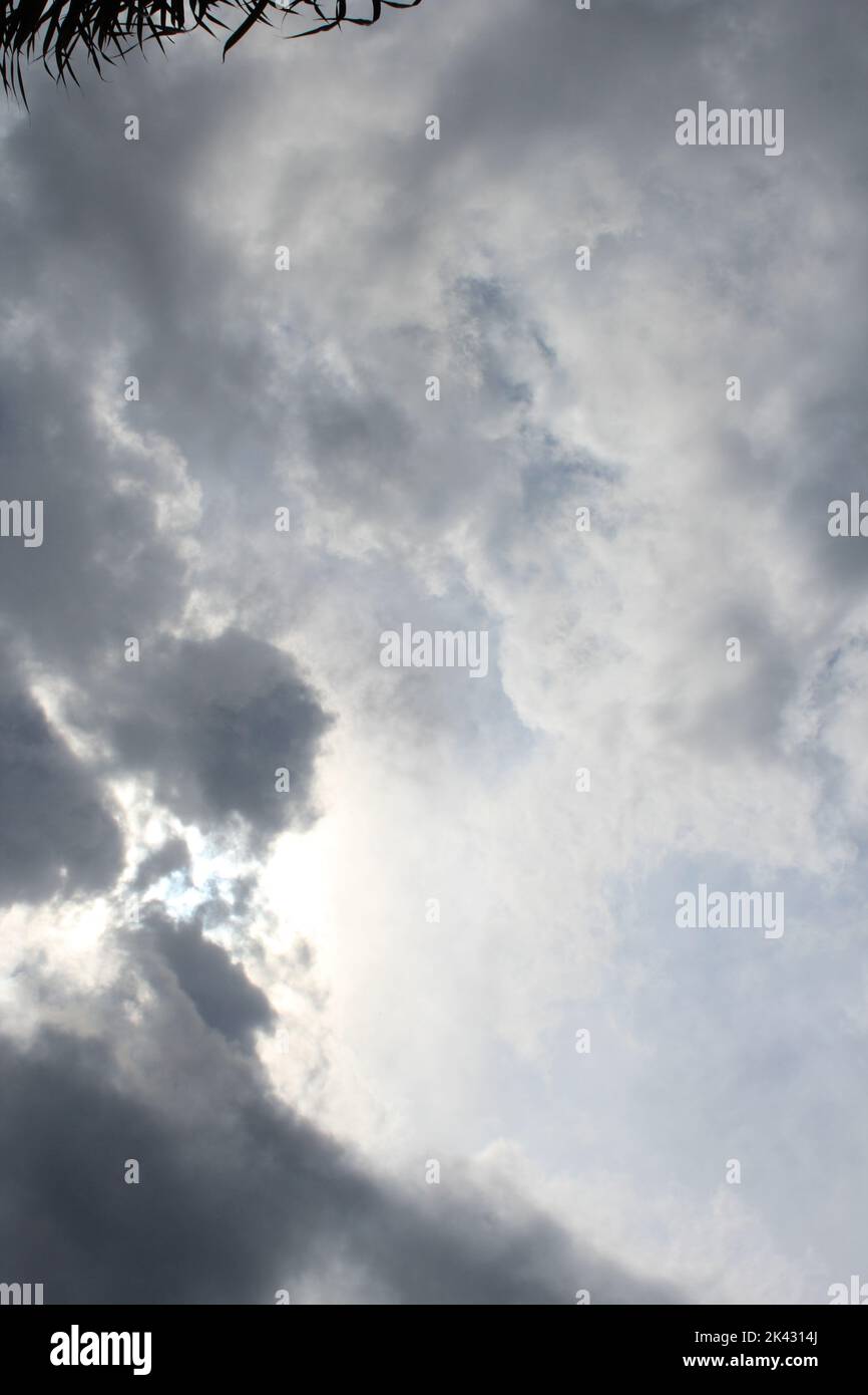 portrait of sun peaking out of the clouds after a storm Stock Photo