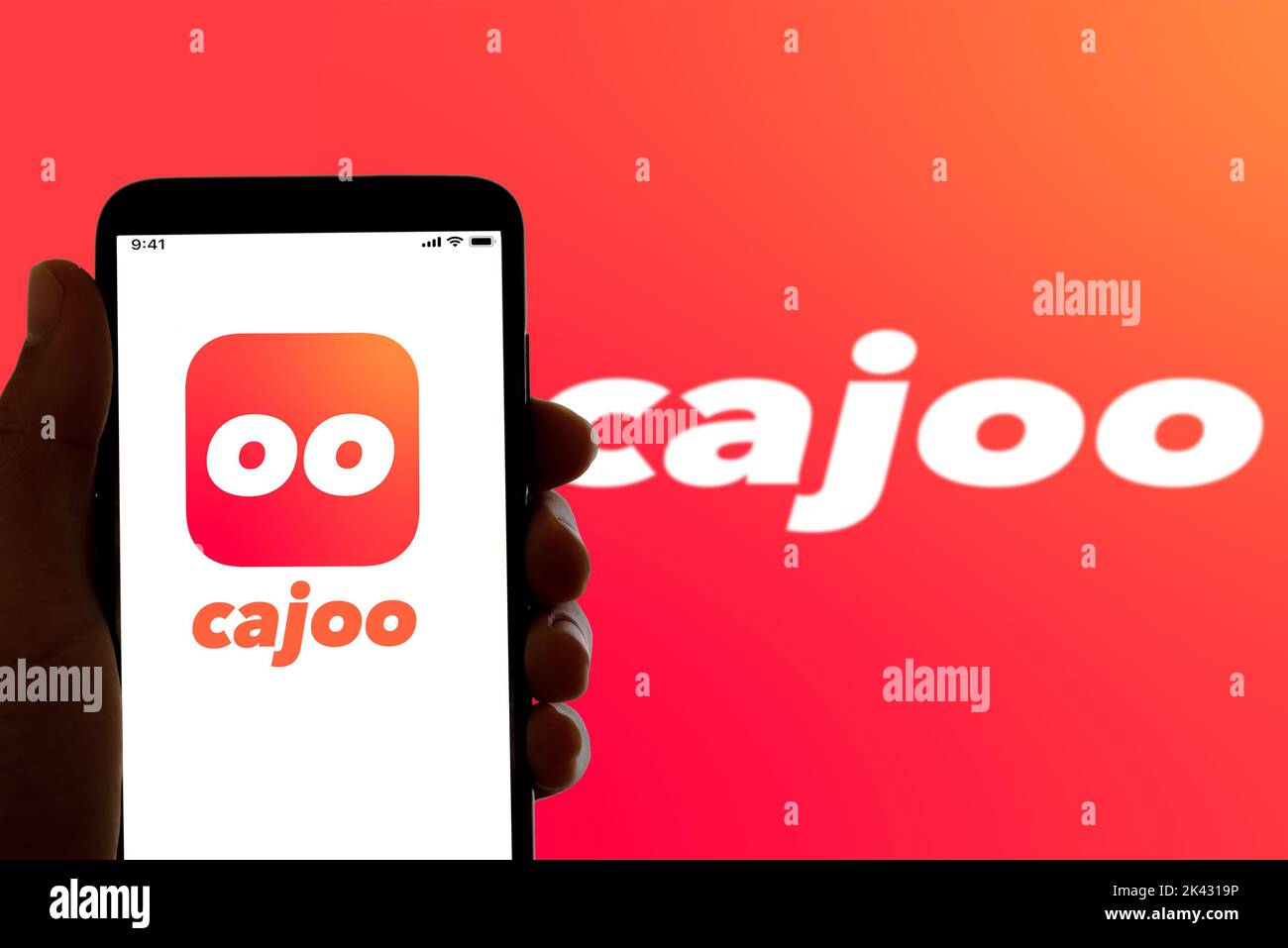 In this photo illustration, the logo of the quick food and grocery delivery Cajoo seen displayed on a smartphone screen. Stock Photo