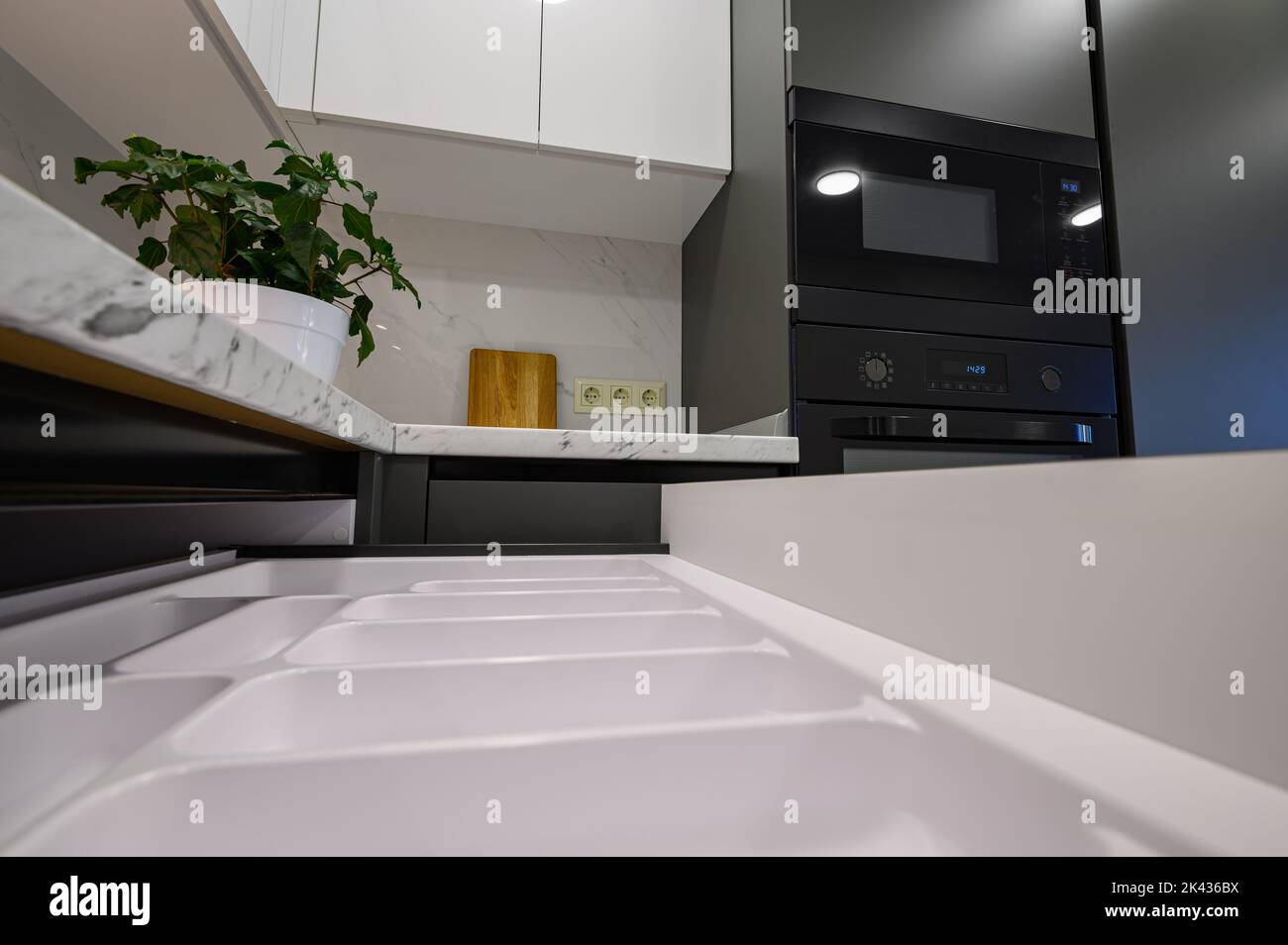 Marble worktop of modern white and dark grey kitchen Stock Photo - Alamy