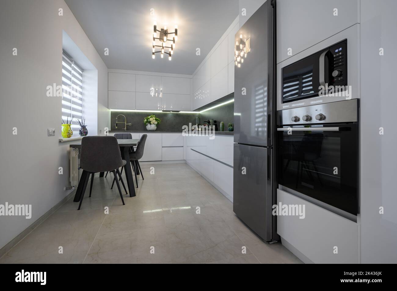https://c8.alamy.com/comp/2K436JK/white-modern-kitchen-with-granite-counter-top-and-marble-floor-2K436JK.jpg