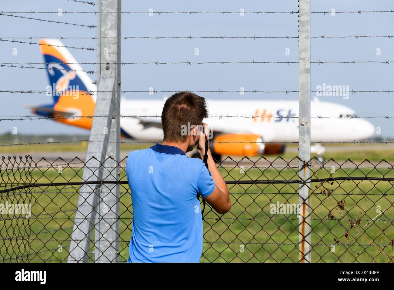 Plane spotter at Otopeni Airport, Bucharest, Romania. Plane spotting hobby consists in observing and photographing aircraf, planespotting by avgeek. Stock Photo
