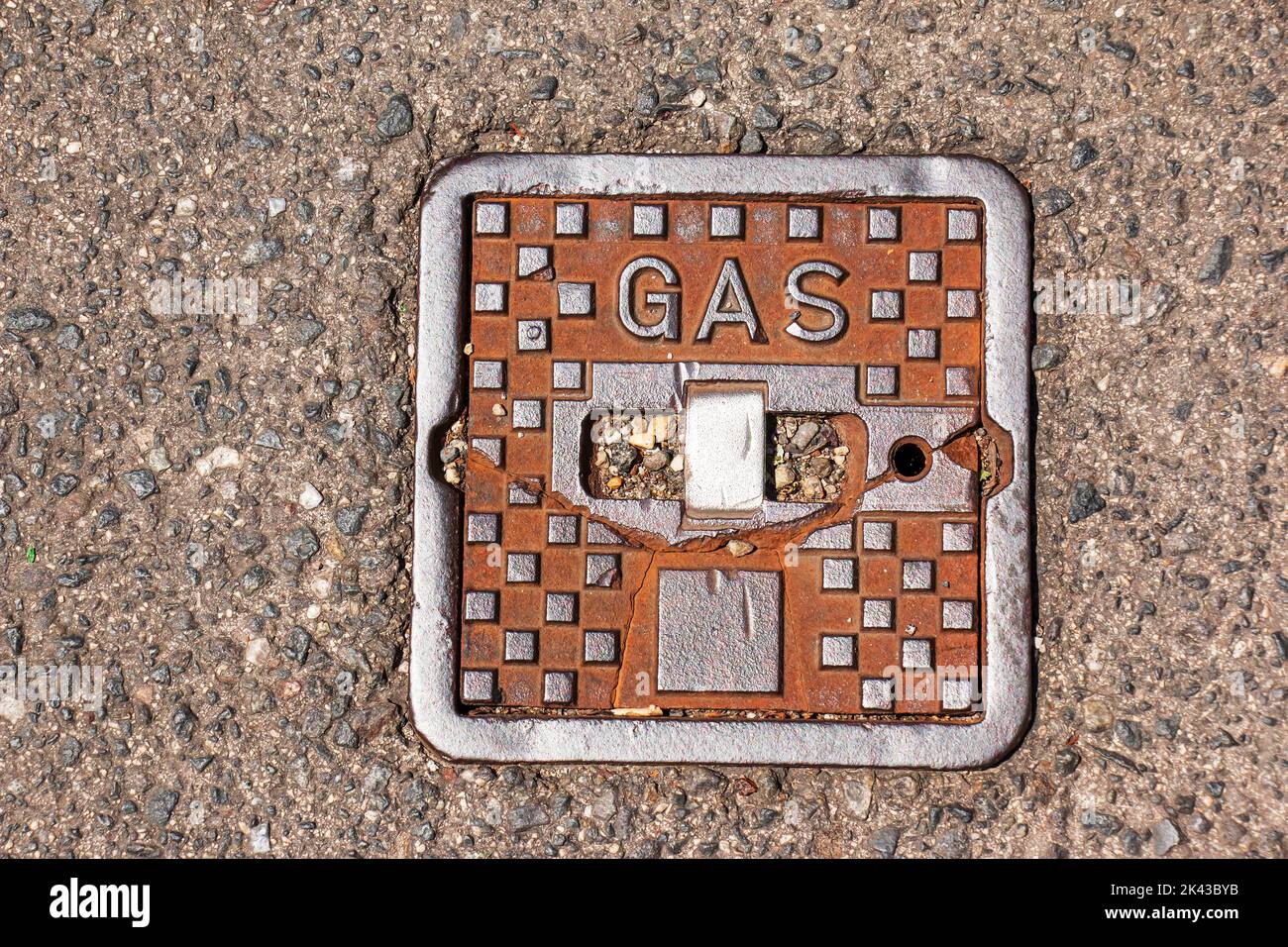 Manhole cover of the gas pipeline system. A massive metal hatch for