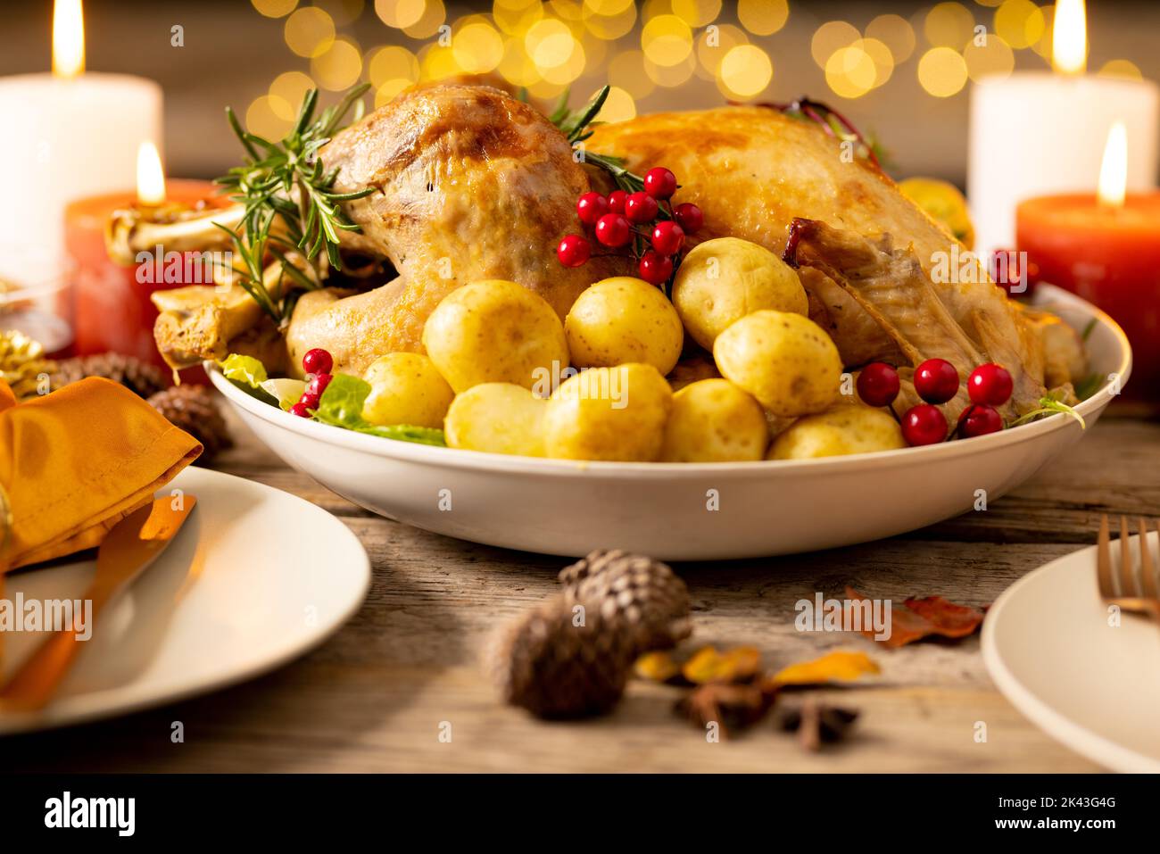 Thanksgiving table with roast turkey, potatoes, candles and autumn decoration Stock Photo