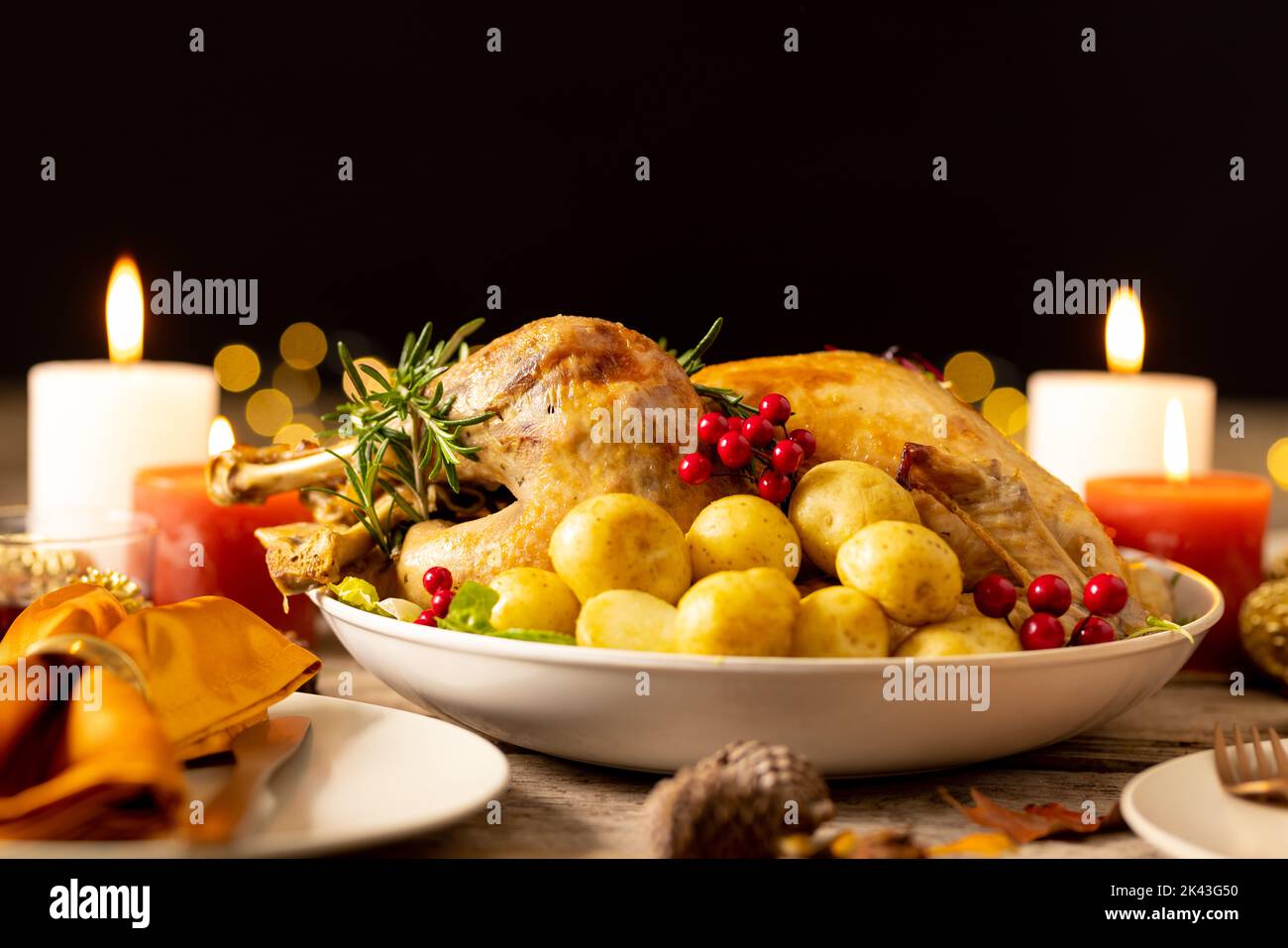 Thanksgiving table with roast turkey, potatoes, candles and autumn decoration Stock Photo