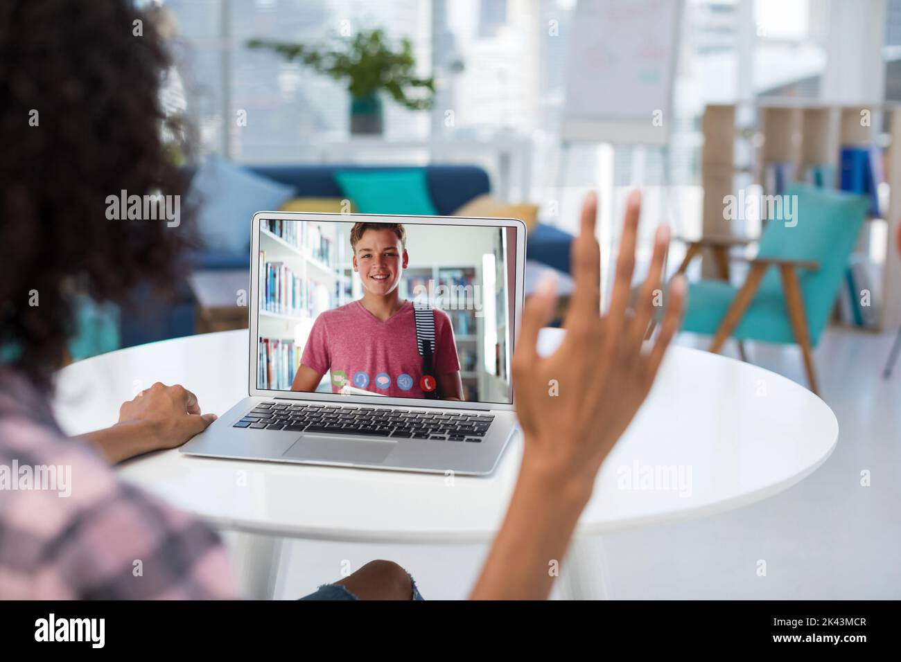 Female teacher having a video call with male student on laptop at ...