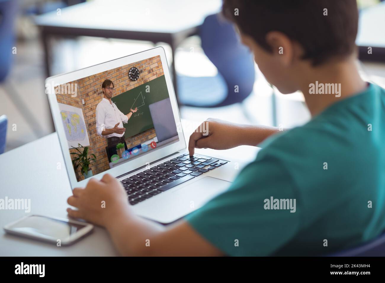 Male caucasian student having a video call with male teacher on laptop ...
